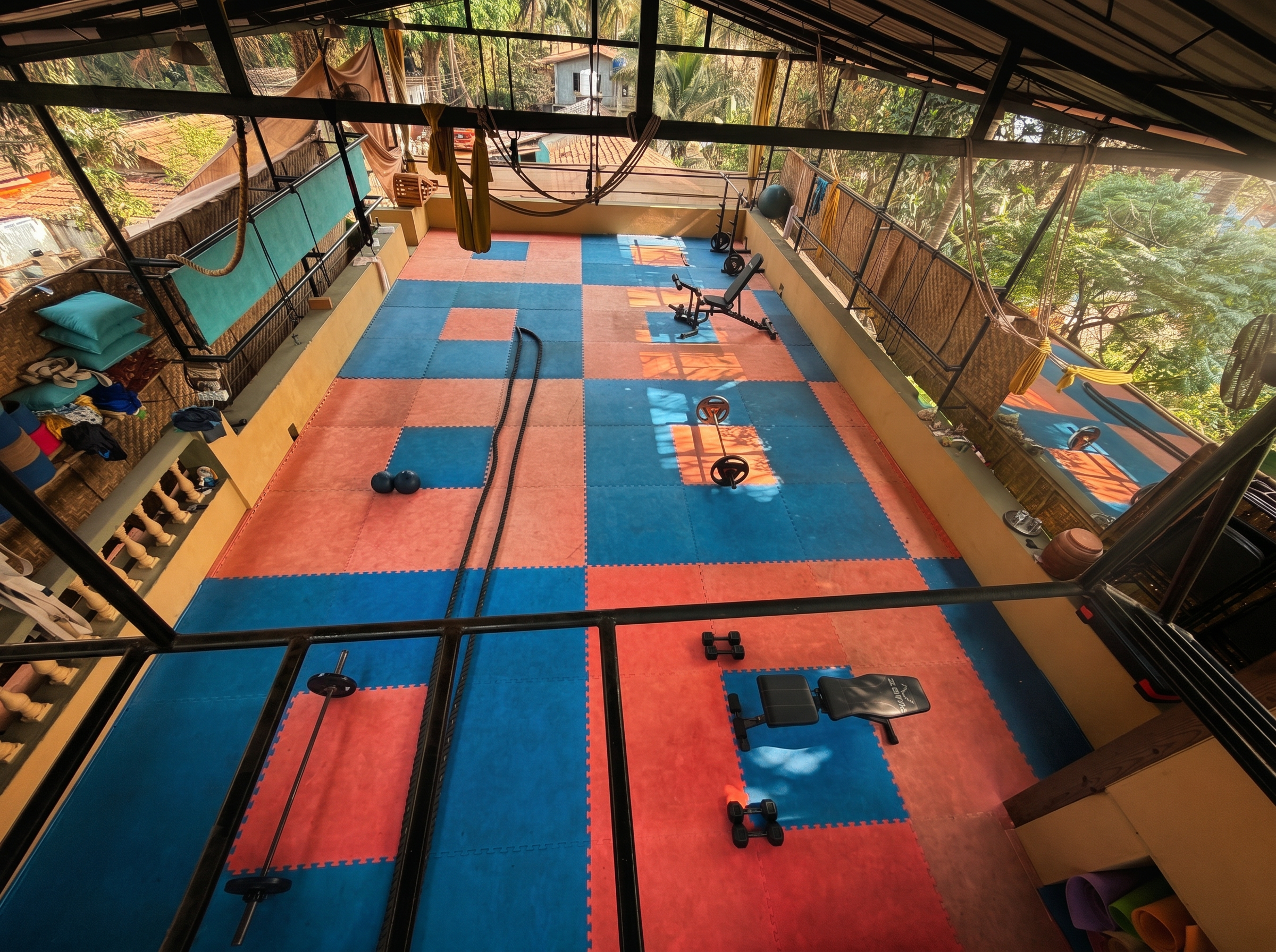 overhead view of the open-air training floor with battle ropes and weights